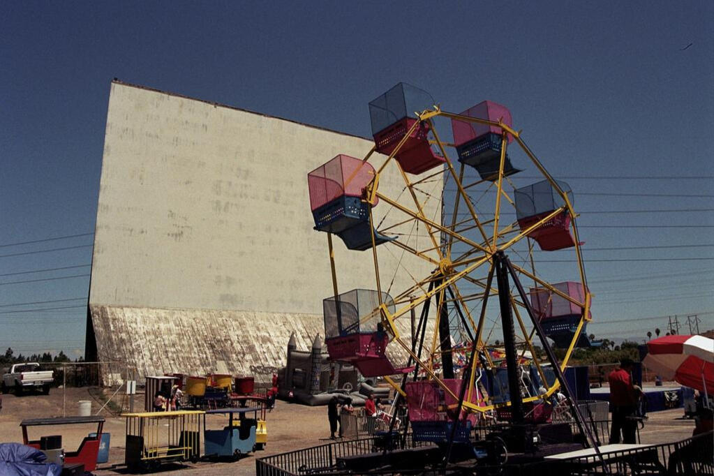 Photo of the Outdoor Oceanside Swapmeet's Ferris Wheel in front of the Old Valley Drive in Movie Screen. Photo provided by sandiego.com